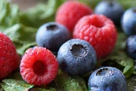 Antioxidant-rich berries and green tea leaves