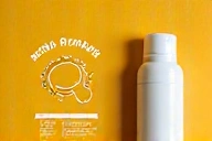 Sunscreen bottle next to a healthy skin diagram